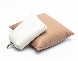 White purse resting on soft, tan, rectangular pillow