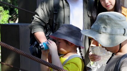 Asian Family Planning Hiking Route with Map and Binoculars in Nature