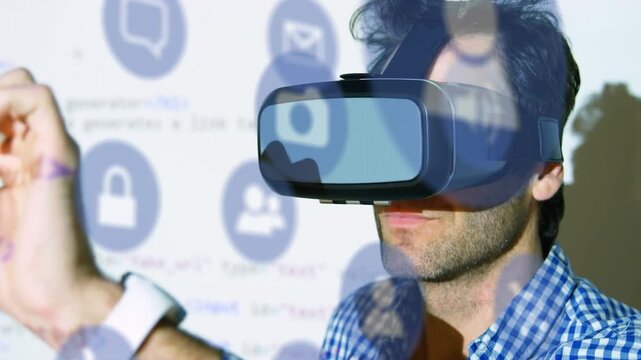 Animation of computer icons over caucasian businessman using virtual reality simulator and gesturing