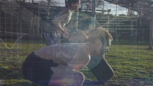 Two young women and a young man flipping tyres at an outdoor gym during a bootcamp training session