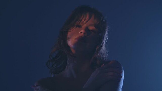 A captivating portrait of a woman cast in dramatic low light, creating a mysterious and alluring atmosphere.
