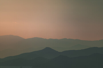 Layered mountain landscape view at sunset, rolling hills in Greece