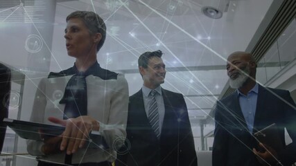 Animation of network of connections against diverse businesspeople discussing at office - Powered by Adobe