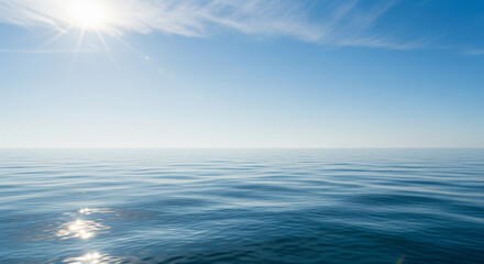 Obraz premium Endless Horizon: Capturing the vastness and serenity of the open sea under a bright, cloudless sky, with the sun's radiant rays adding a touch of brilliance. This image is about peace and tranquility.