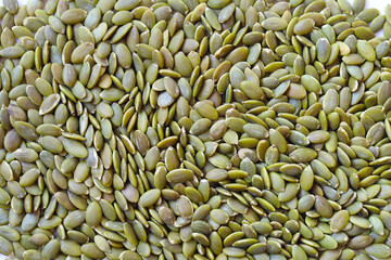 Obraz premium Delicious peeled green pumpkin seeds