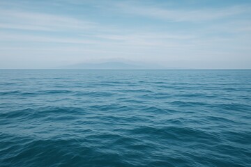 Calm ocean water surface under a blue sky with distant mountains on horizon, serene seascape landscape with peaceful and tranquil atmosphere concept. Ai generative