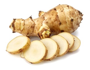 A close-up shot of a beige, knobby root vegetable, with some sliced pieces revealing a light interior, presented on white