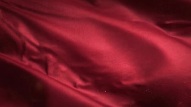 Abstract red fabric texture with soft folds and shadows