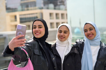 Three muslim women taking selfie