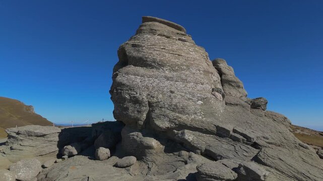 Dynamic Aerial Reveal of The Sphinx Rock Close Up to Wide Bucegi Plateau and Prahova Valley 4K