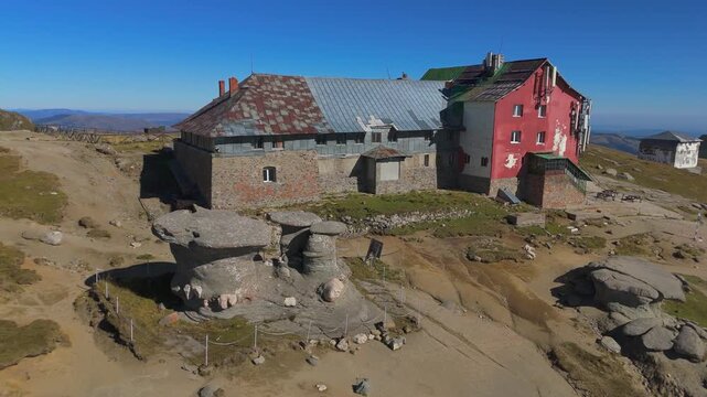 Wide Aerial Orbit Over Babele Rock Formations Revealing Chalet and Costila Peak Relay 4K