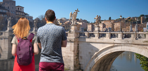 A man and woman in love looking at the city in Rome