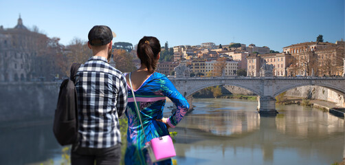 A man and woman in love looking at the city in Rome