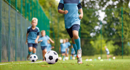 Youth Soccer Training Drill. Kids Running With Footballs During Practice Session on Outdoor Grass Field