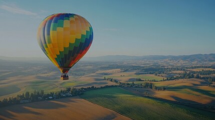 Obraz premium Colorful hot air balloon over a vast, golden landscape