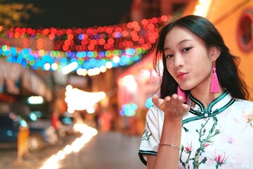 Young Girl Celebrating New Year with Colorful Lights at Night
