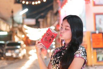 Young Girl Celebrating with Red Envelopes in Festive Atmosphere