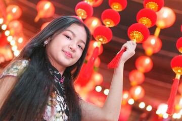 Young Girl Celebrating New Year Surrounded by Lanterns and Decorations