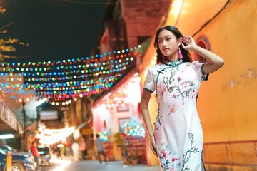 Young Woman in Traditional Dress Celebrating New Year in Colorful Street