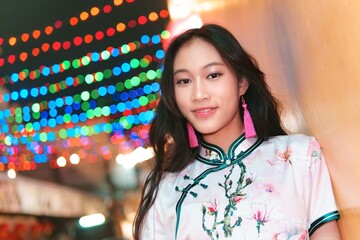 Young Girl Celebrates New Year with Colorful Lights and Joyful Vibe