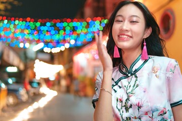 Joyful Young Girl Celebrating New Year with Colorful Lights Background