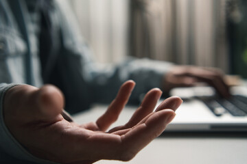 People hand open for addiing graphic design, sign icon or text while working on a laptop. Concept of giving, receiving, or showing virtual object element