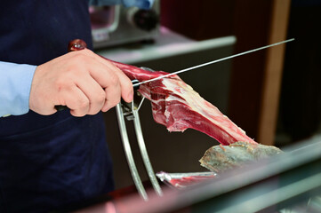 Man Slicing Spanish Jamon with Knife
