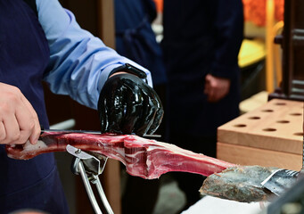 Man Slicing Spanish Jamon with Knife