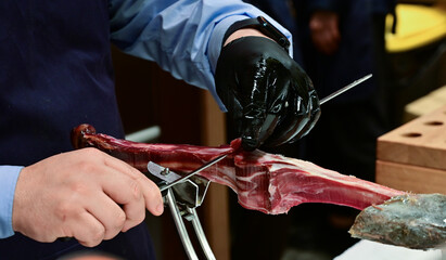 Man Slicing Spanish Jamon with Knife
