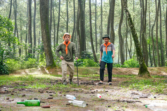 Two Hikers Discover Trash While Exploring Forest - Powered by Adobe