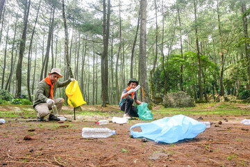Dedicated Volunteers Cleaning up Plastic Waste in Lush Forest Environment