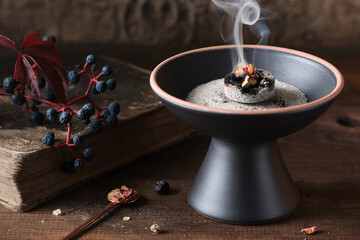 Mabon incense ritual with frankincense, resins, and dried herbs - spiritual mood © efoArt