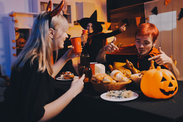 Friends enjoying a Halloween party at a bar making a toast