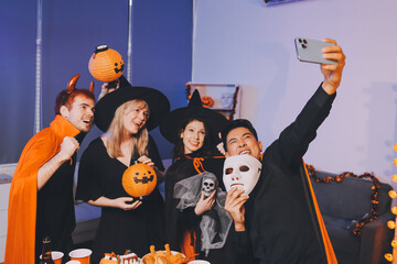 Friends enjoying a Halloween party at a bar making a toast