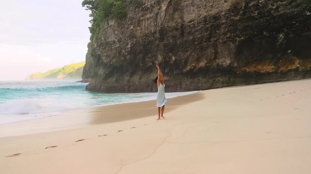 Joyful Woman Spinning In Dress On Kelingking Beach Cliffs In Bali