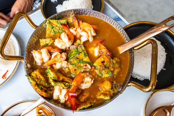 Acacia leaf omelet and shrimp in spicy sour soup and rice on plate, Thai food. Image on top view.