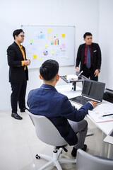 Professionals Working Together In Modern Office Setting With Focus On Collaboration And Strategy