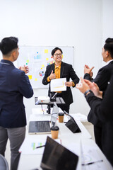 Business Team Celebrates Successful Presentation In Modern Office Setting