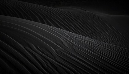 Abstract, dark, textured landscape resembling black sand dunes with flowing, parallel lines and subtle gradients