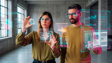 Holographic data analysts adjusting performance dashboards inside an industrial workspace