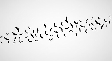 Fototapeta premium Black bat silhouettes arranged in a curved line against a white background, creating a Halloween-themed design ideal for banners or invitations, showcasing free space for text
