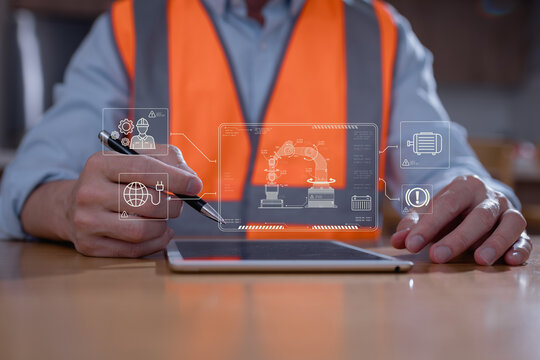 Engineer using digital tablet to control and monitor robotic arm system in smart factory. Industrial automation, predictive maintenance, and IoT technology in manufacturing innovation concept. - Powered by Adobe