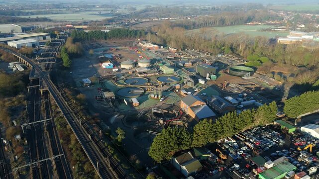 Top down aerial of wastewater infrastructure in Rugby UK with circular settling tanks and active water aeration systems for environmental protection