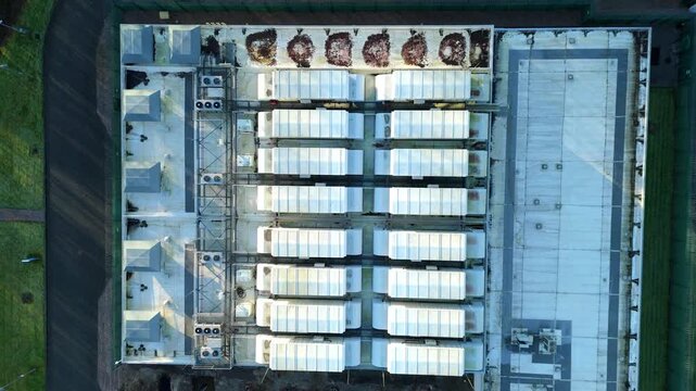 Top down aerial view of large scale data center, ATOS quantum AI computing, cloud storage and technology campus, cooling fans and turbines near Birmingham, United Kingdom