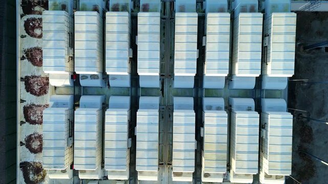 Top down aerial view of large scale data center, ATOS quantum AI computing, cloud storage and technology campus, cooling fans and turbines near Birmingham, United Kingdom