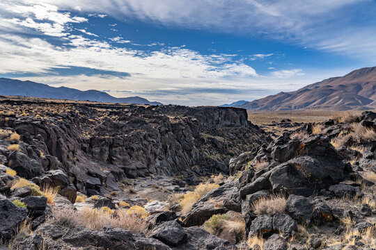 Volcanic rock, Basalt flows. Fossil Falls Trail, Coso Volcanic Field, Inyo County, California.  Coso Range, Basin and Range Province. In the distance is Sierra Nevada ( mountain range )