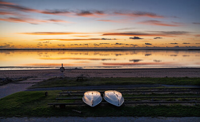 Tranquil Sunset Beach With Silhouette Walker Along Calm Shoreline At Dusk, Hjerting, Esbjerg, Denmark
