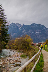 Mountain path along a river leading through a rural village