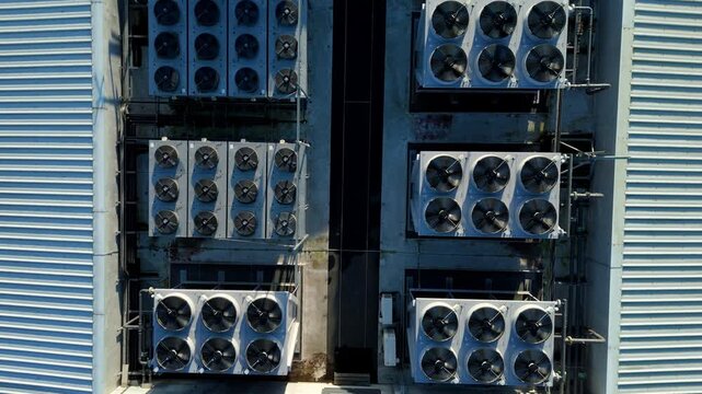 Close up aerial drone view of HVAC air conditioning units and cooling fans turbines on Data center roof, Quantum computing and cloud storage IT critical infrastructure in Redditch, United Kingdom