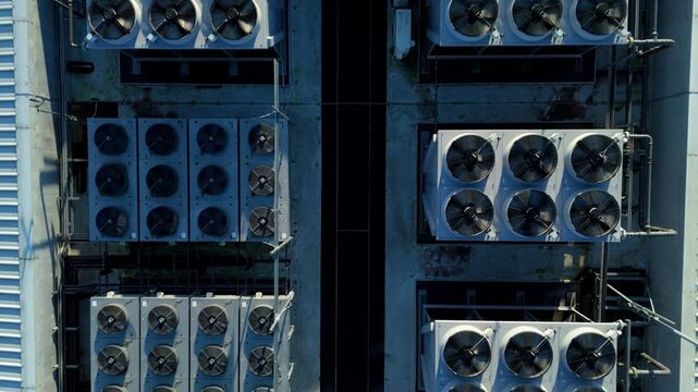 Close up aerial drone view of HVAC air conditioning units and cooling fans turbines on Data center roof, Quantum computing and cloud storage IT critical infrastructure in Redditch, United Kingdom